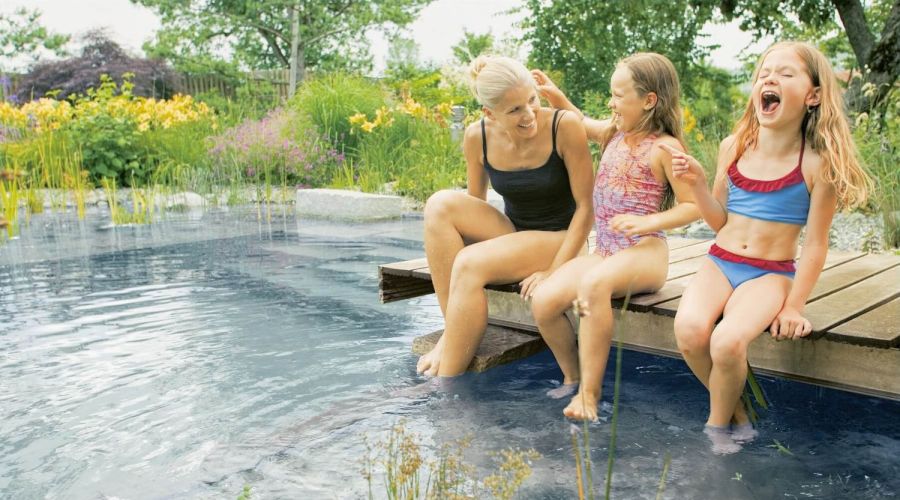 Familie entspannt im Schwimmteich
