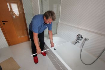 Mann vermisst die Größe einer Badewanne