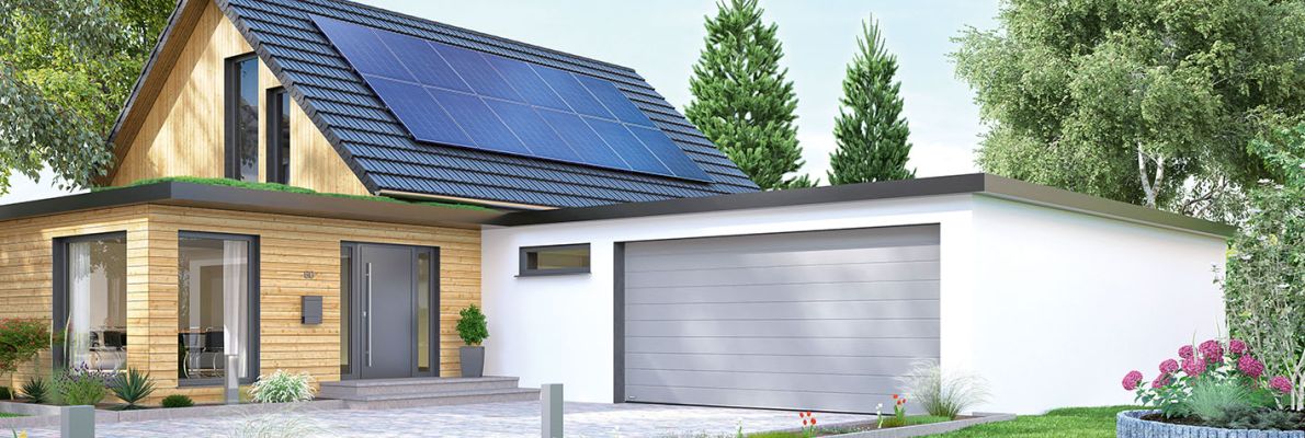 Einfahrt mit verschlossener Garage vor einem modernen Wohnhaus